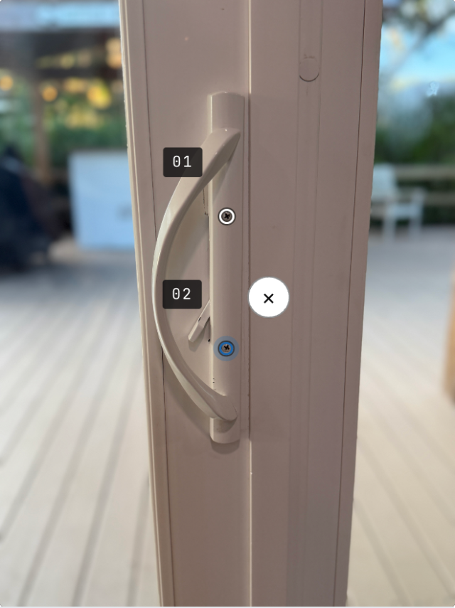 The same handle with both screw heads ringed and numbered