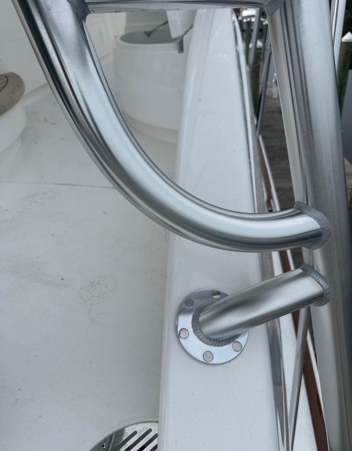 Welded aluminum tower joint with flush-fastened base plate