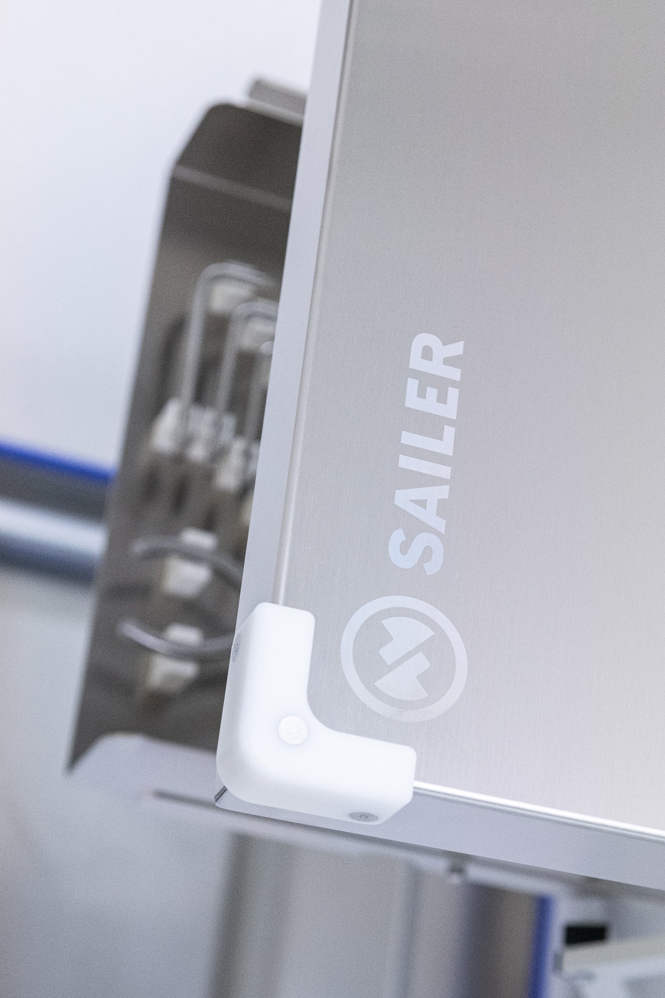 Brushed stainless panel with flush fastener detail in a cleanroom environment