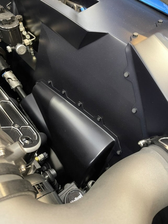Flush fasteners integrated into a matte composite panel in a performance vehicle engine bay